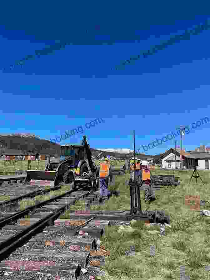 A Crew Of Laborers Working Diligently To Lay Down Tracks, With The Arduous Terrain And Sprawling Landscape Stretching Beyond Them. The Building Of The Transcontinental Railroad (Graphic History)