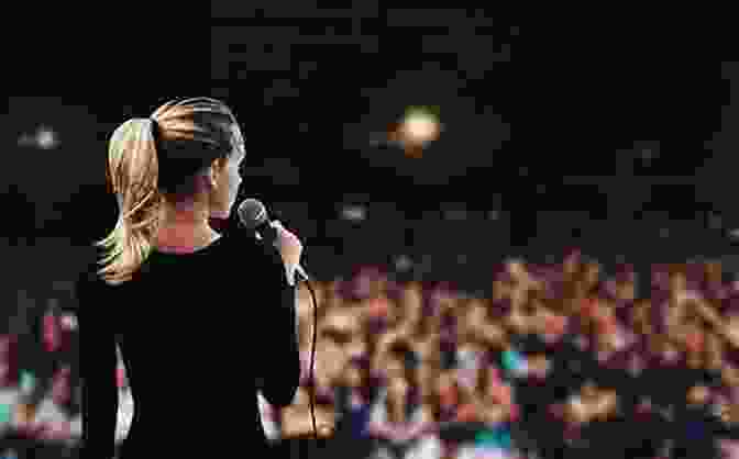 A Woman Standing On A Stage, Speaking To A Crowd. She Is Holding A Microphone In Her Hand. Platform: Get Noticed In A Noisy World