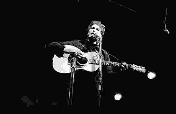Bob Dylan Performing Live On Stage, With A Microphone In His Hand And A Guitar Strapped Around His Shoulder Michael Jackson: All The Songs: The Story Behind Every Track